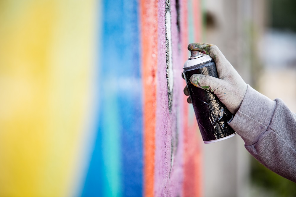 Graffiti Artist Drawing Graffiti on Wall